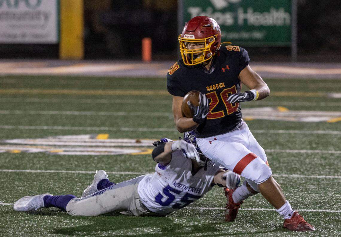Kamiakin senior Luis Salgado dodges North Creek junior Brady Goff during the first round 4A state tournament game at Lampson Stadium in Kennewick. Salgado had over 100 yards of total offense — seven carries for 64 yards rushing, 2 catches for 41 yards. The Braves won against the Jaguars 56-21.