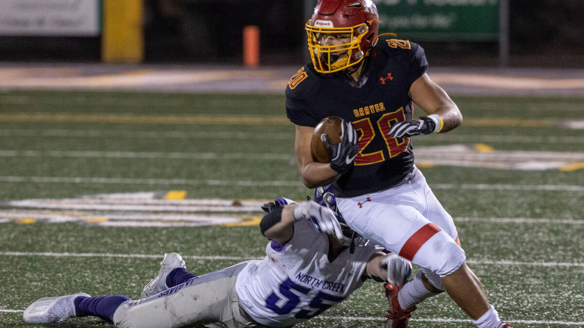 Kamiakin senior Luis Salgado dodges North Creek junior Brady Goff during the first round 4A state tournament game at Lampson Stadium in Kennewick. Salgado had over 100 yards of total offense.