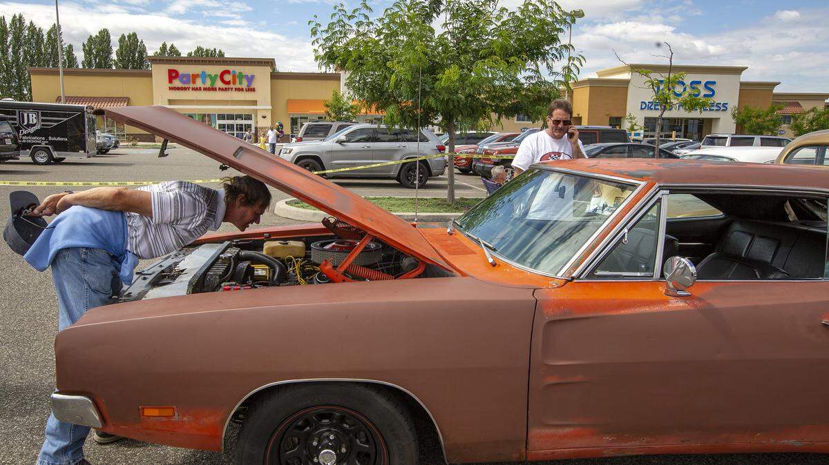 Two car enthusiast look at a 1968 Dodge Charger 500 at Les Schwab Show N’ Shine in Richland during Cool Desert Nights on Friday. The family friendly four day event features classic cars, street rods, and motorcycles, food, and entertainment.