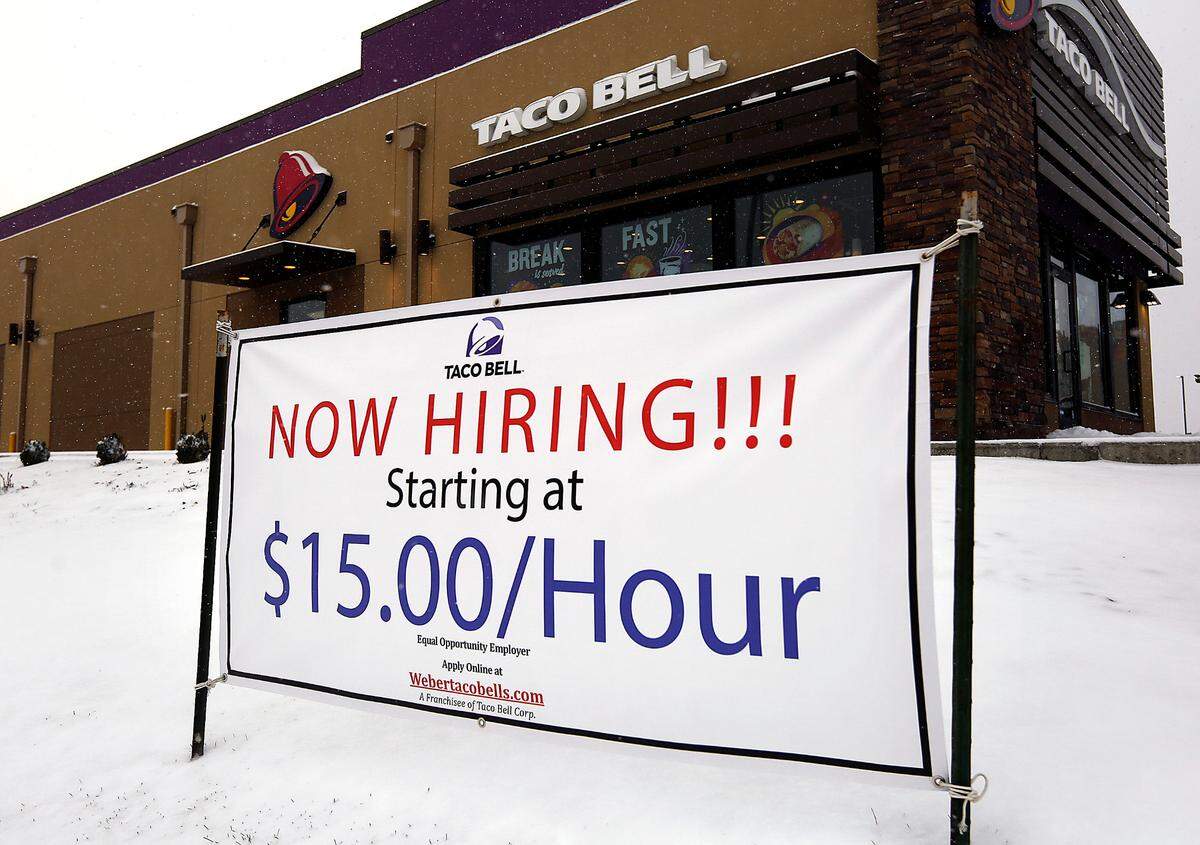 A sign outside a Taco Bell fast food restaurant in south Kennewick advertises that the business is looking to hire employees.