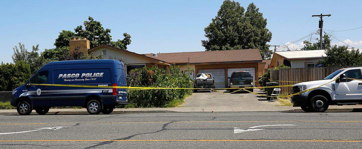 Pasco police are parked outside a Marie Street home where a woman was killed early Wednesday in a garage converted into an apartment.