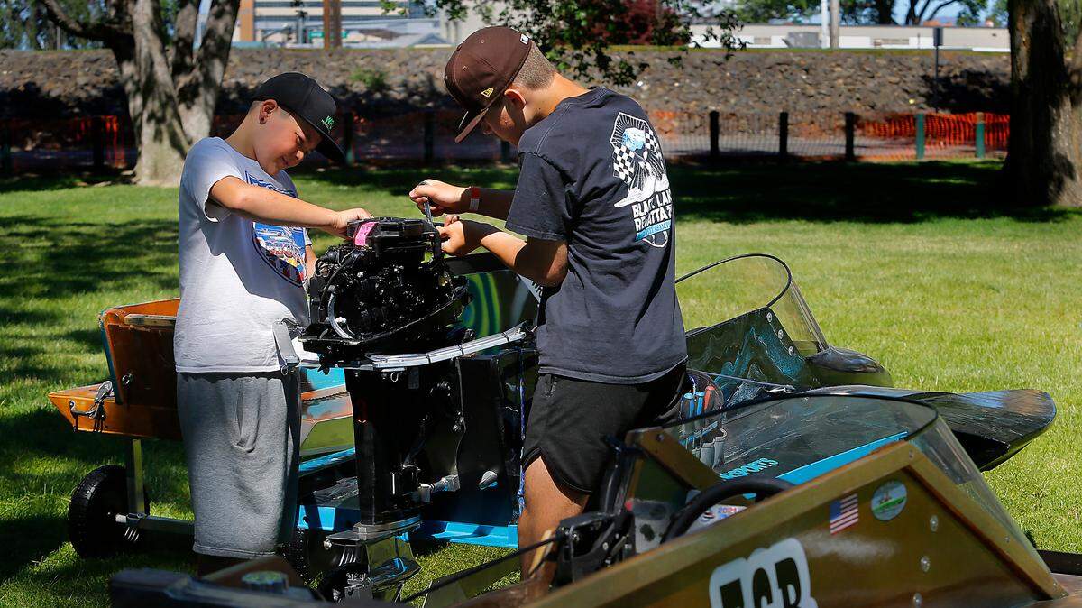 Boat racing friends Kannon Cushing, 11, left, and Julian Waite, 12, work together Thursday in the pits preparing their outboard hydropane race boats for the Richland Regatta. The three-day event, starting June 24, is on the Columbia River in Howard Amon Park. Admission is free and there will be food vendors. Drivers in the park can expect road closures and detours. River traffic near the park will also be closed because of the racing event. For more information visit the Northwest Powerboat Association’s website at www.nwpba.com/.