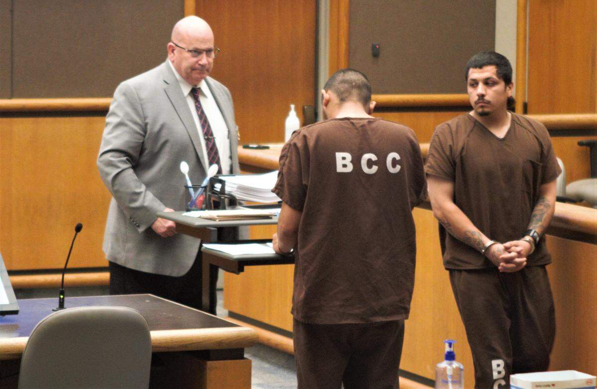 Ramon Candido walks past Hector Munguia in Benton Franklin Superior Court on Tuesday, April 26, 2022. Both men are awaiting charges related to April killings.