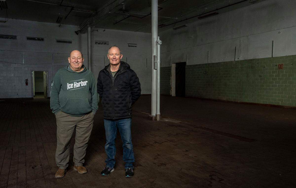 Mike Hall and Bill Jaquish, the co-owners of Ice Harbor Brewing Company, stand in part of the old Welch’s Grape Juice plant in downtown Kennewick. The building, which most recently housed JLieb Foods, Inc., will be the new flagship location of the Tri-Cities brewery.