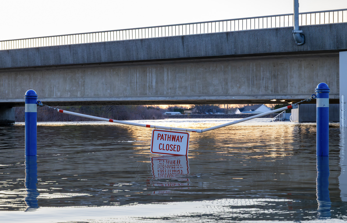 Floodwater from the Yakima River covers the pedestrian pathway beneath the Van Giesen Street bridge in West Richland on Sunday, March 22, 2026, forcing a closure as river levels continue to rise toward minor flood stage.