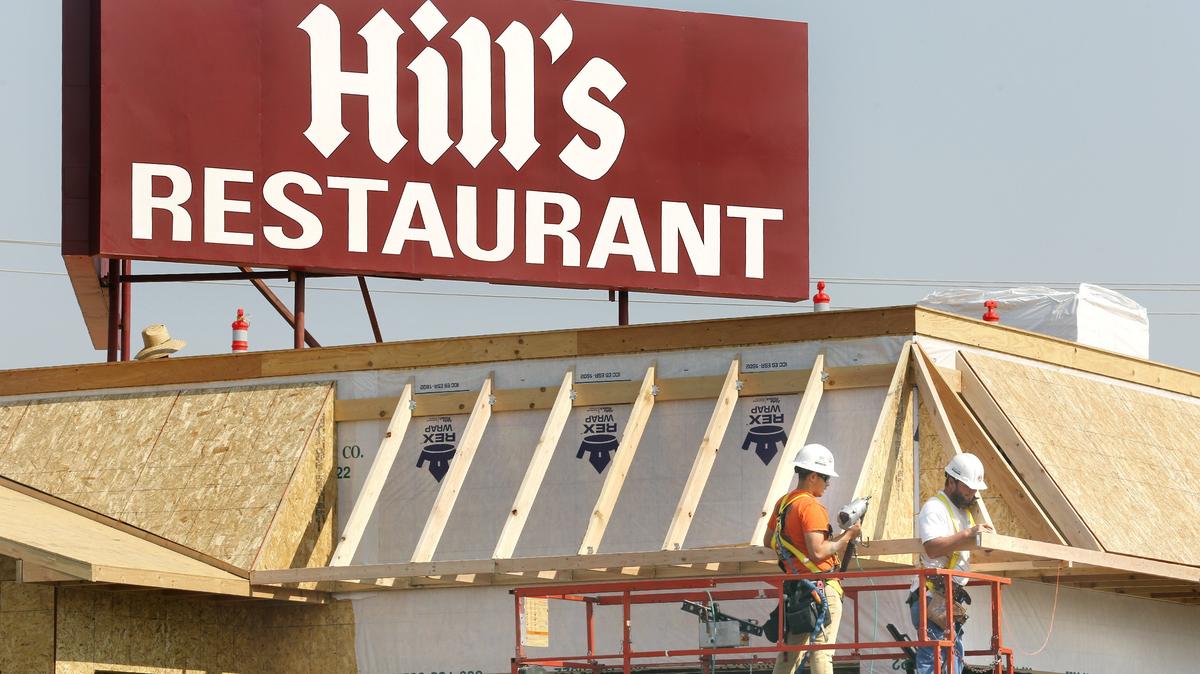 G2 Construction workers Jose Rodriguez, left, and Jimmy Childress team up Tuesday on rebuilding Hill’s Restaurant, 24 Vista Way in Kennewick. A kitchen fire closed the popular eatery in October 2016. Much of the fire-damaged building was torn down earlier this year and crews have been busy rebuilding it. They recently added the landmark sign. Owner Nancy Galstad expects to re-open later this year.