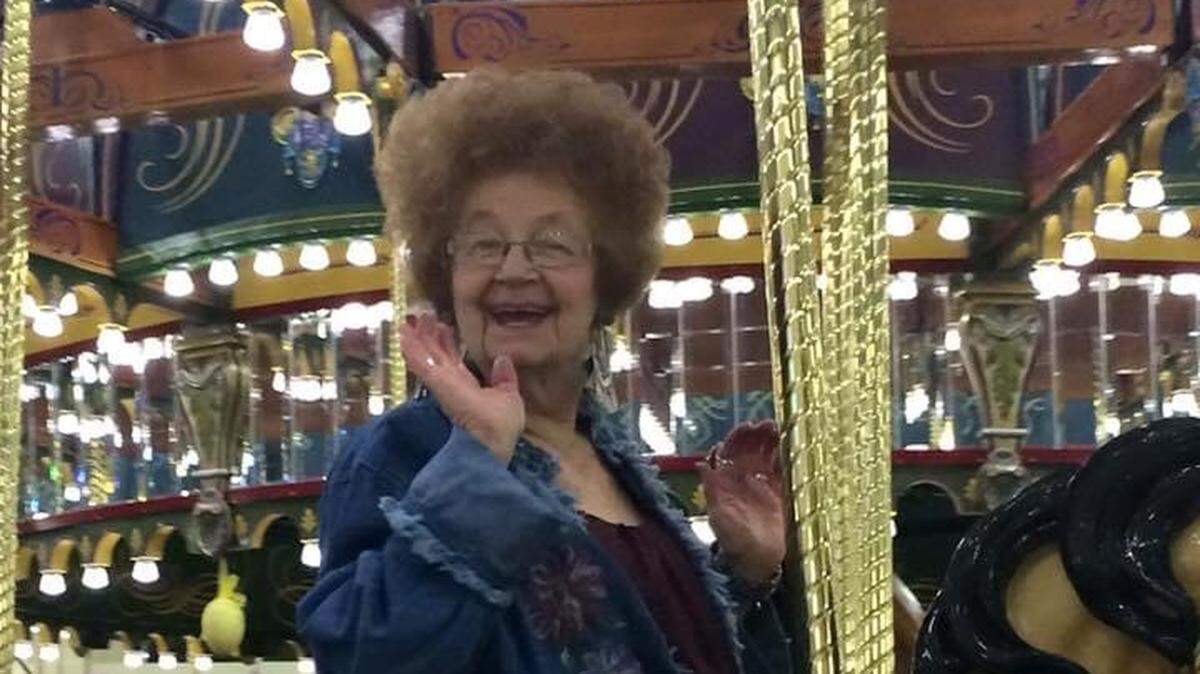 Wilma Robison Burgess of Pasco is pictured here riding on the Carousel of Dreams. Some of her former students want Park Middle School renamed for her.