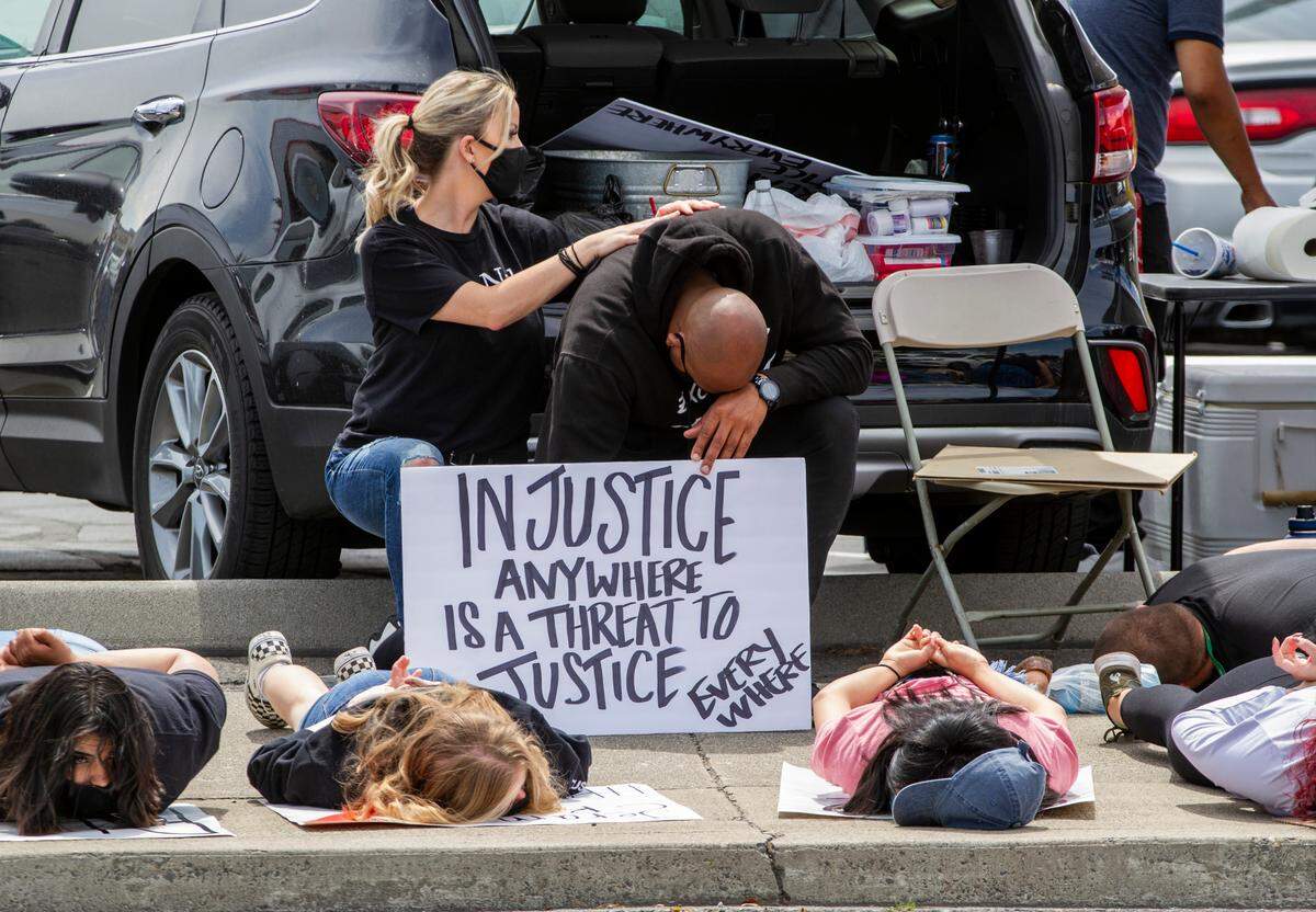 Demonstrators kneel or lie down for eight minutes and 46 seconds to honor George Floyd during a peaceful protest in Pasco on Saturday. Eight minutes and 46 seconds is the same amount of time that Officer Derek Chauvin knelt on George Floyd’s neck. 