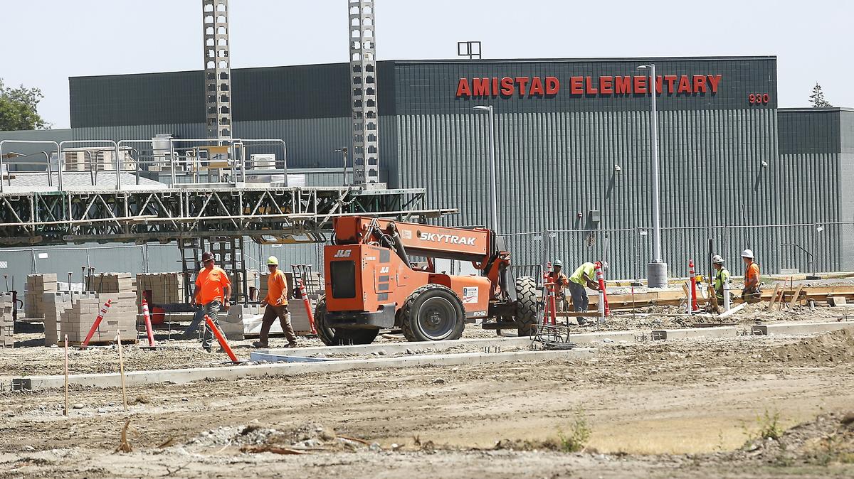 Construction workers and equipment move around the site of the new detached addition of Amistad Elementary School in Kennewick. The first phase of the school’s renovation includes 22 classrooms, gym, and office space being built adjacent to the existing 1992 structure at 930 W. 4th Ave. The estimated $18 million first phase is being paid for by a K-3 class size reduction grant from the state. The second phase to replace the existing school and connect the two buildings is estimated at $19 million and is pending voter approval of a 2019 bond. The new section is expected to open in August 2019.