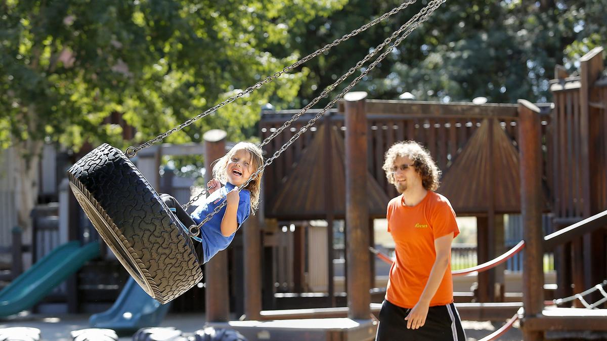 Jace Quinn, 4, and his father Zac of Kennewick enjoy one last visit Thursday to the Playground of Dream’s in Kennewick’s Columbia Park. The 19-year old wooden structure is closing and will be rebuilt in two phases, finished in November and the spring.