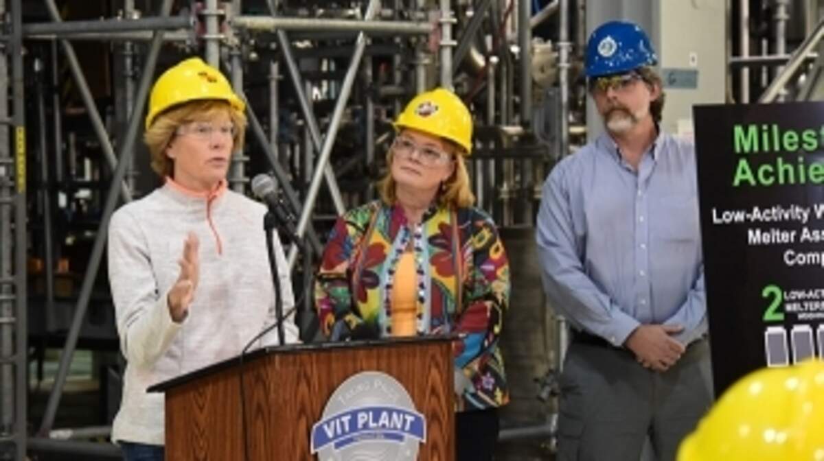 Alex Smith, left, program manager for the Washington state Department of Ecology’s Nuclear Waste Program, speaks at a celebration marking the completion of the assembly of two melters at the Hanford nuclear reservation’s vitrification plant.