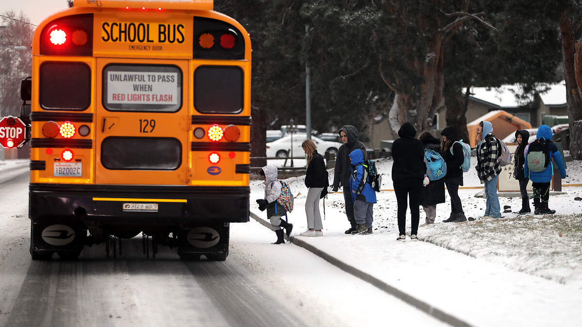 Kennewick elementary students board their school bus on West Metaline Avenue in Kennewick. The overnight snowfall, that measured less than an inch in most places, did not cause many delays or closures in the Tri-Cities. But many outlying and rural schools were on a two hour delay.