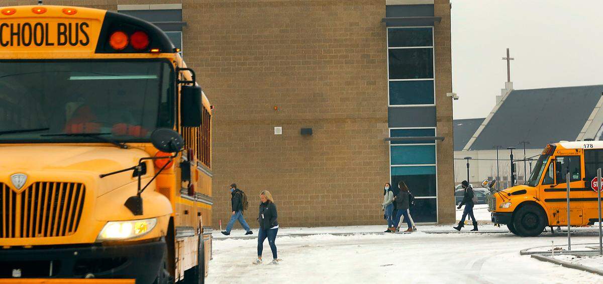 Students at Kennewick High School make their way to their classrooms Wednesday morning following a two-hour delay caused by slick roadways from an overnight winter storm that coated the region with freezing rain.
