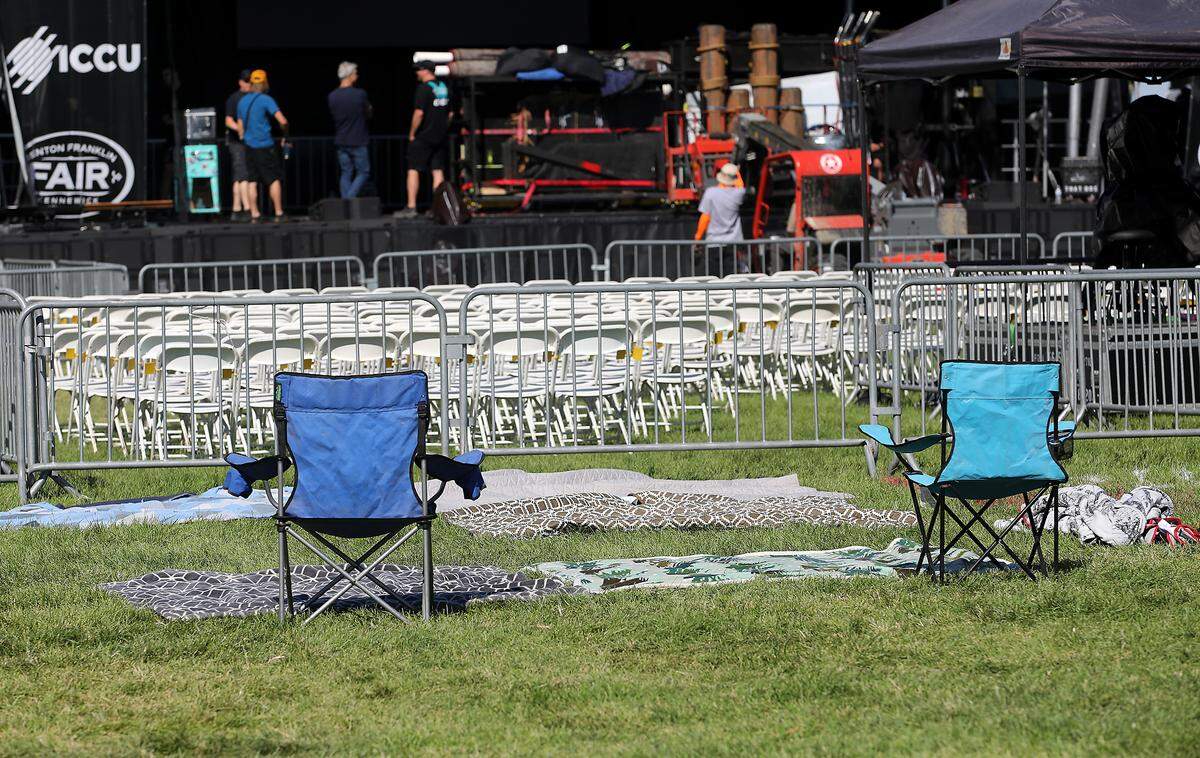 Chairs and blankets save spots as the main stage is being set up early for the evening concert by country music performer Jake Owen at the Benton Franklin Fair & Rodeo in Kennewick.