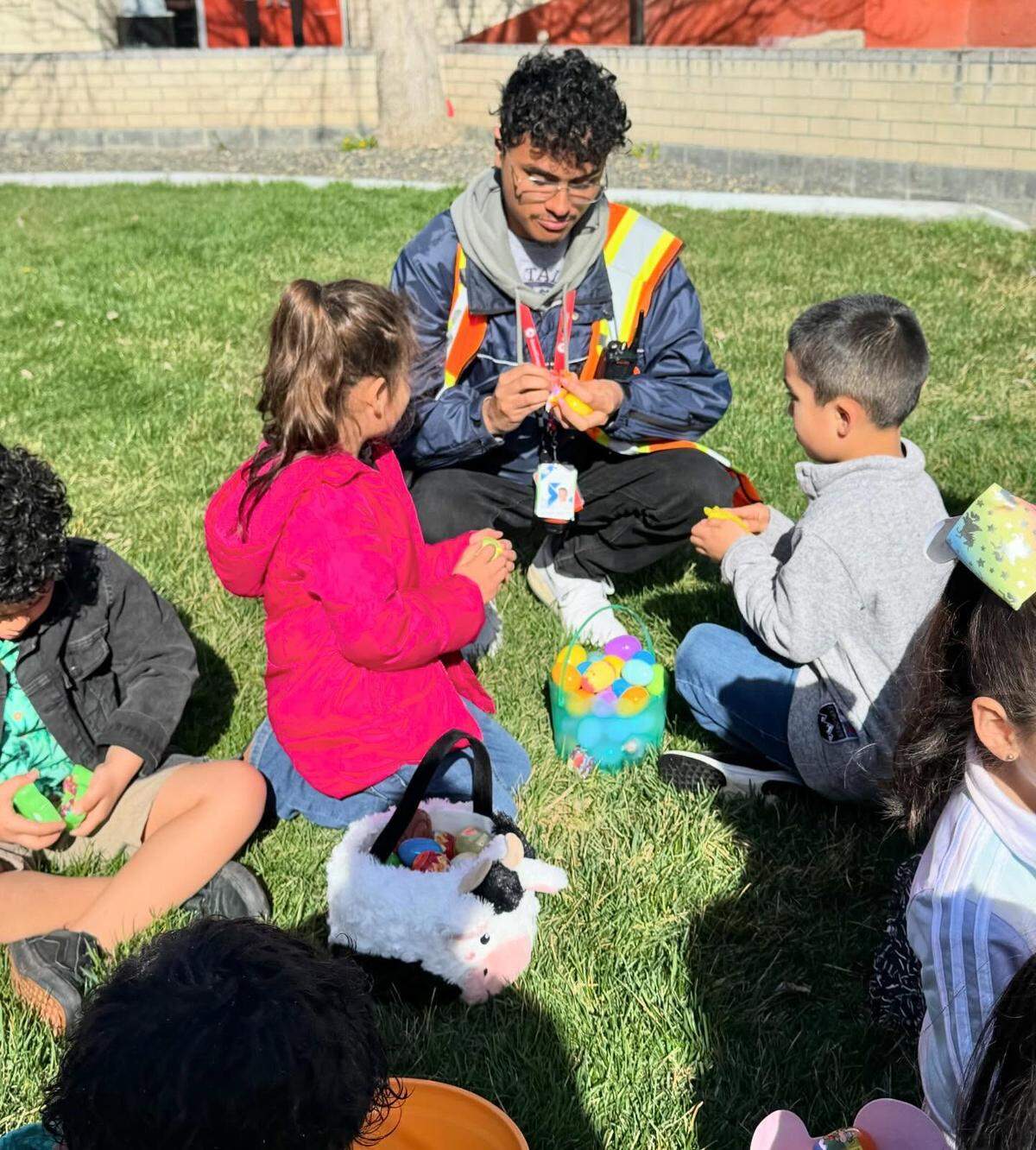 A Serve Tri-Cities AmeriCorps volunteer helps with an Easter egg hunt at Captain Gray Elementary School in Pasco.