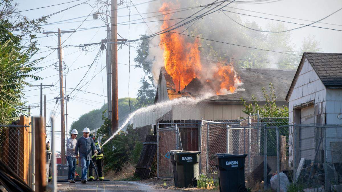 Pasco firefighters work to control a fire that spread from an abandoned house to this occupied home at 920 S. 5th Ave. shortly before 7 a.m. Saturday. Everyone got out safely, said Ben Shearer with the Pasco Fire Department. A small fire at a electrical substation in Pasco also is blamed for a power outage downtown on Friday night.