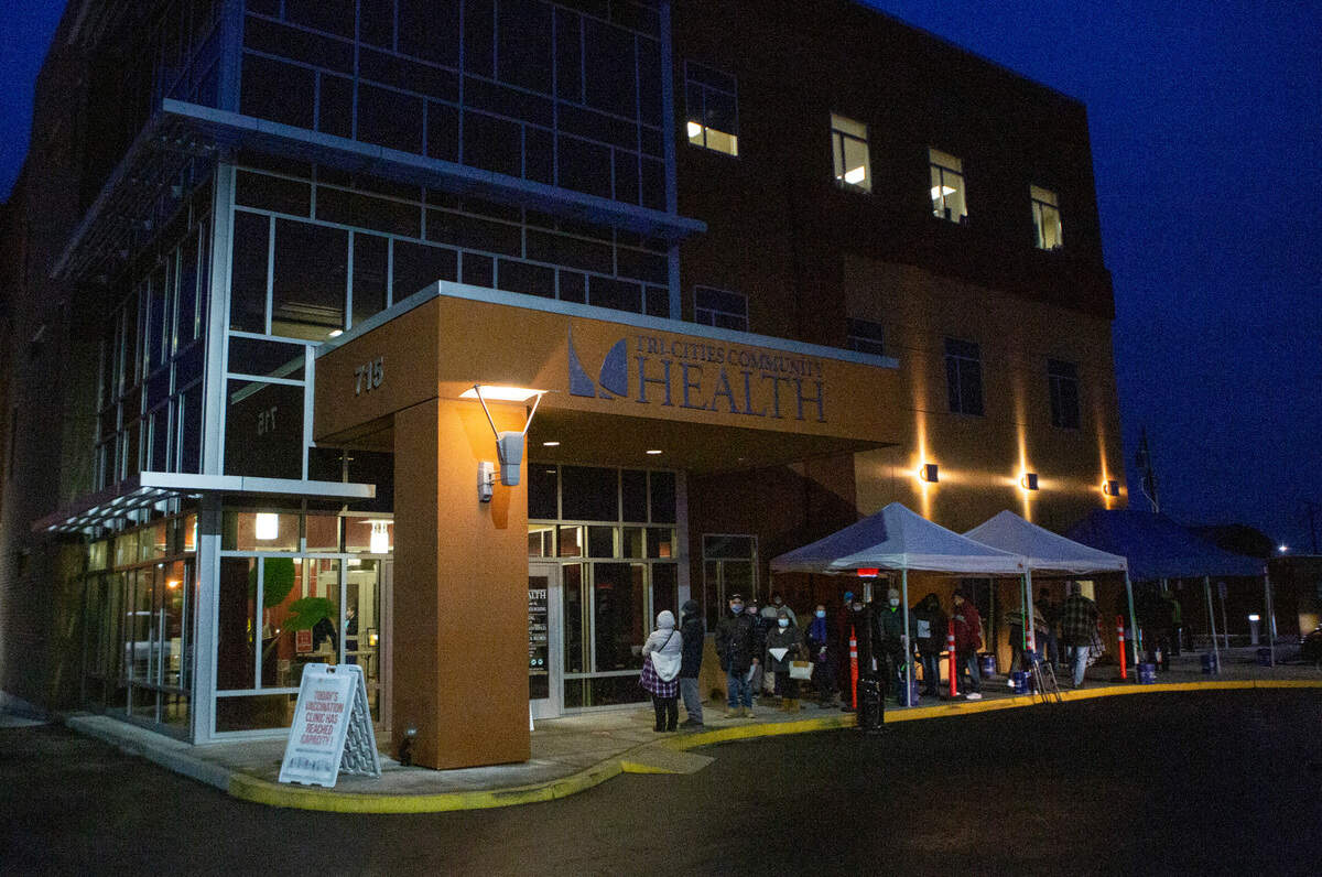 People stood for hours outside in the winter cold waiting for a chance to receive the COVID-19 vaccination at Tri-Cities Community Health clinic in Pasco on Friday.