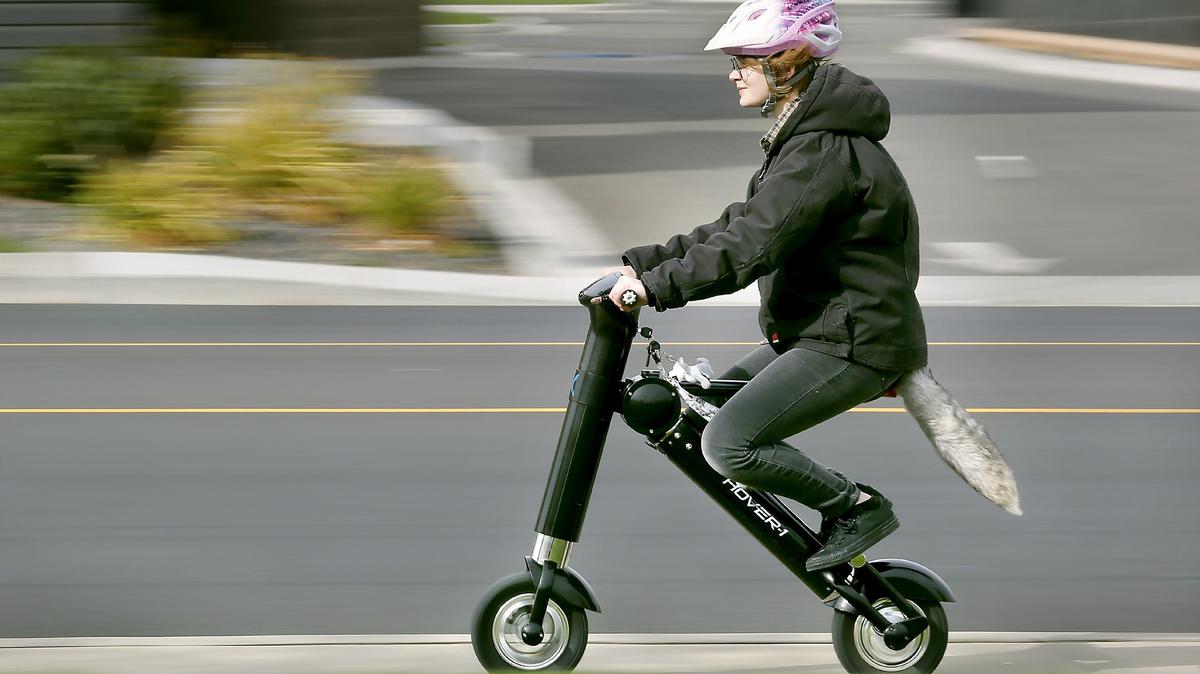 Zjé Seely, 19, of Kennewick enjoys a cruise Friday morning on her new ride, a battery-powered scooter, on South Union Street in Kennewick. She plans to use the rechargeable scooter that has an estimated top-speed of 20-mph and a range of about 22 miles to run errands and for getting back-and-forth to work. It features a headlight, turn signals and even a horn.