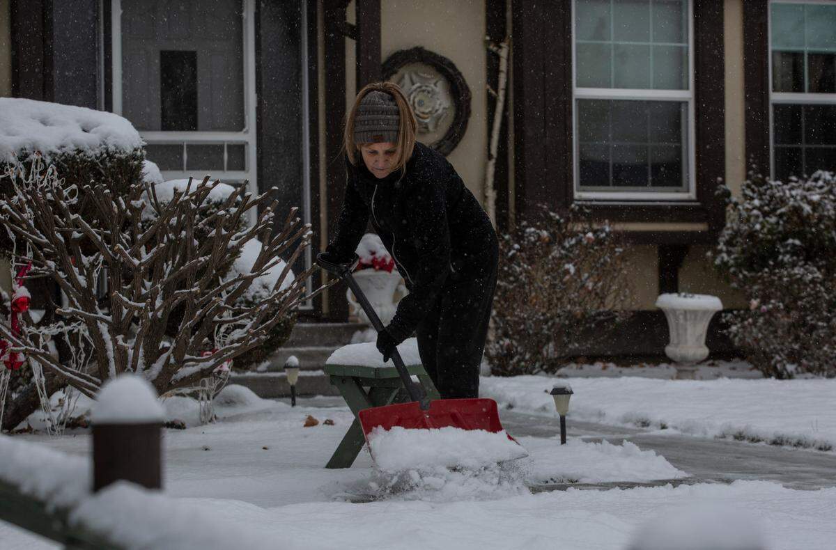 Tressie Matthews, of Kennewick, clears a path from her door to her driveway Thursday morning. Intermittent snowfalls have blanketed the Tri-Cities throughout the week and frigid temperatures due to Arctic air blowing into the northwest have prevented earlier accumulation from melting completely. Temperatures are predicted to warm above freezing on Monday, according to the National Weather Service.