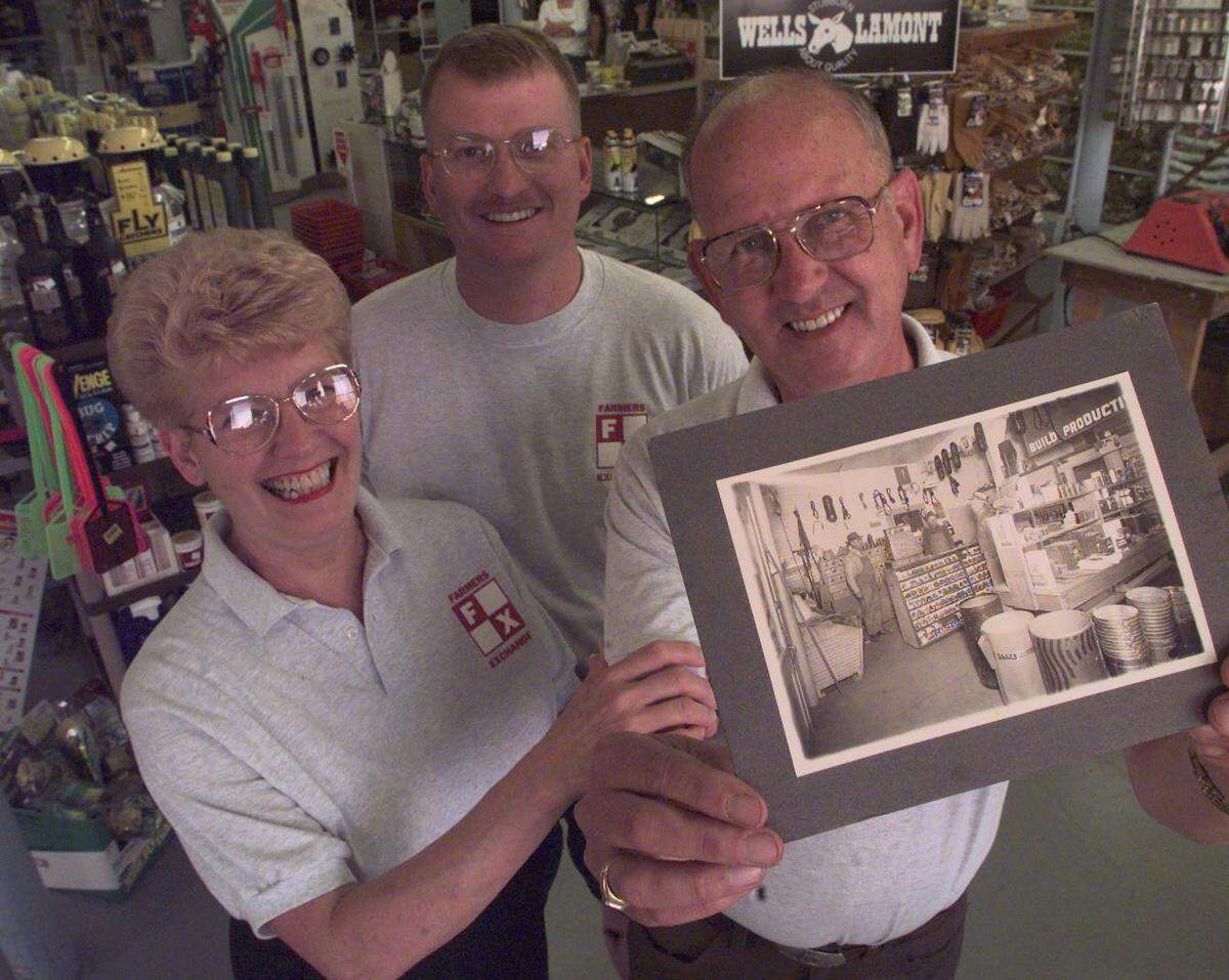 Ken Silliman received Farmers Exchanged from his father, E.A. Silliman, standing at the left in the photograph Ken is holding, which shows the store in 1938 or 1939. Also shown are Ken’s wife, Arlene, and son, Keith.