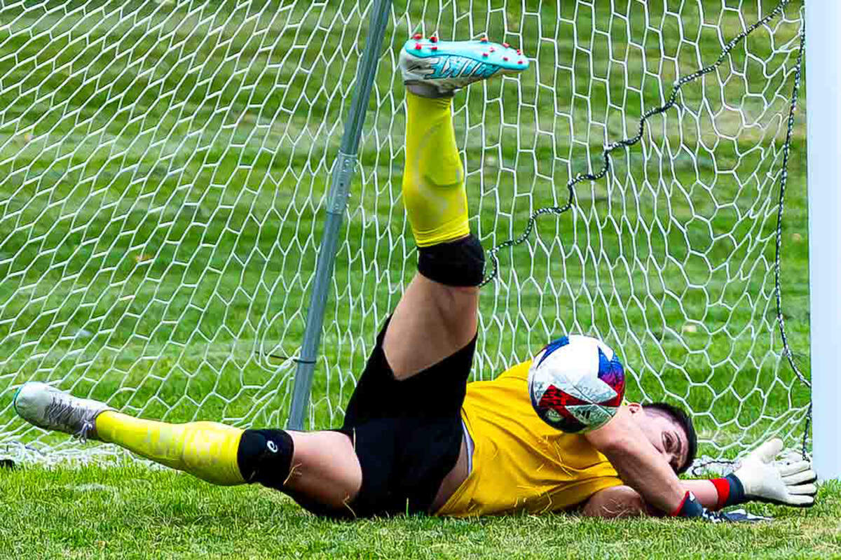 Ernesto Toscano dives for the ball in front of goal.