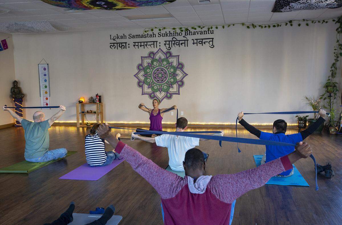 Cecelia Owczarski leads a yoga class with clients from The Arc Tri-Cities at The Lotus Pad in Kennewick.