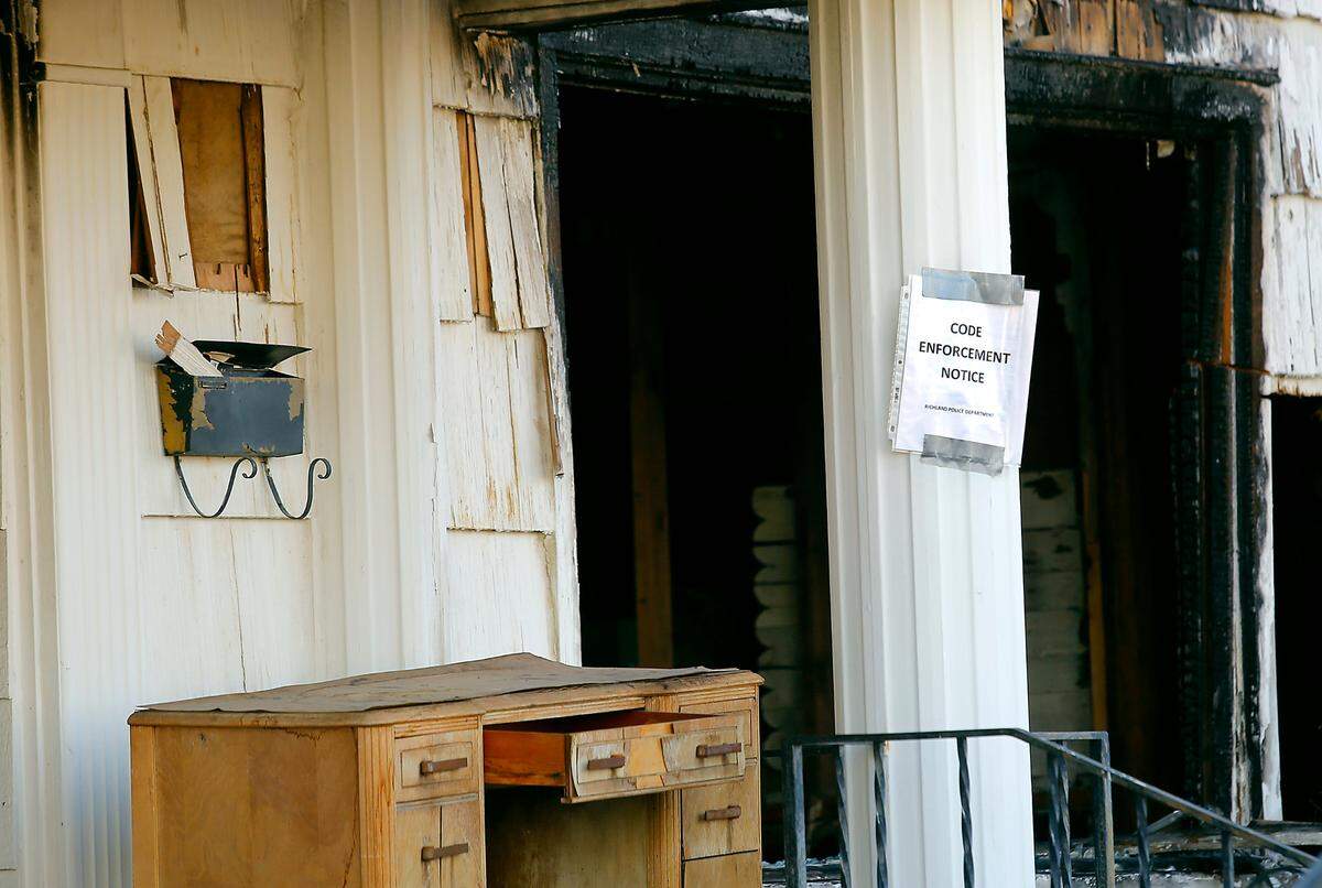 A code enforcement notice has been posted by the Richland Police Department at a dilapidated house destroyed by firein July 2020.