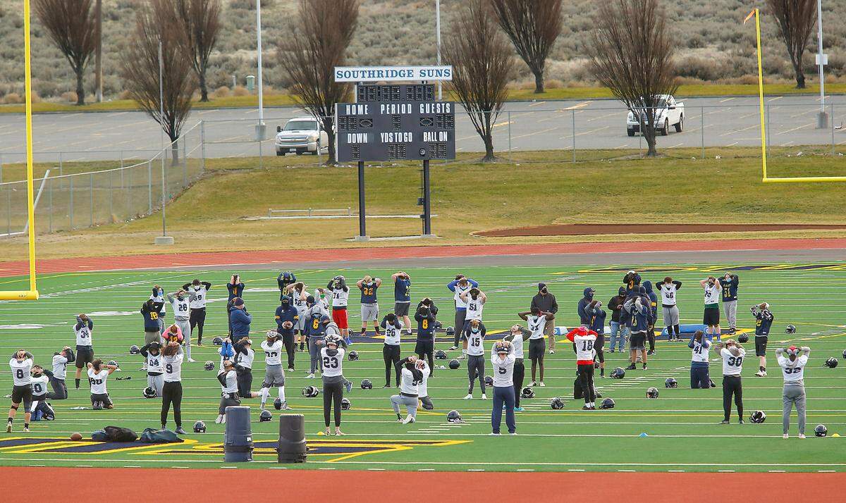 Coaches and players of the Southridge High School football team take to the practice field earlier this month in Kennewick in preparation for the season that begins Feb. 26.