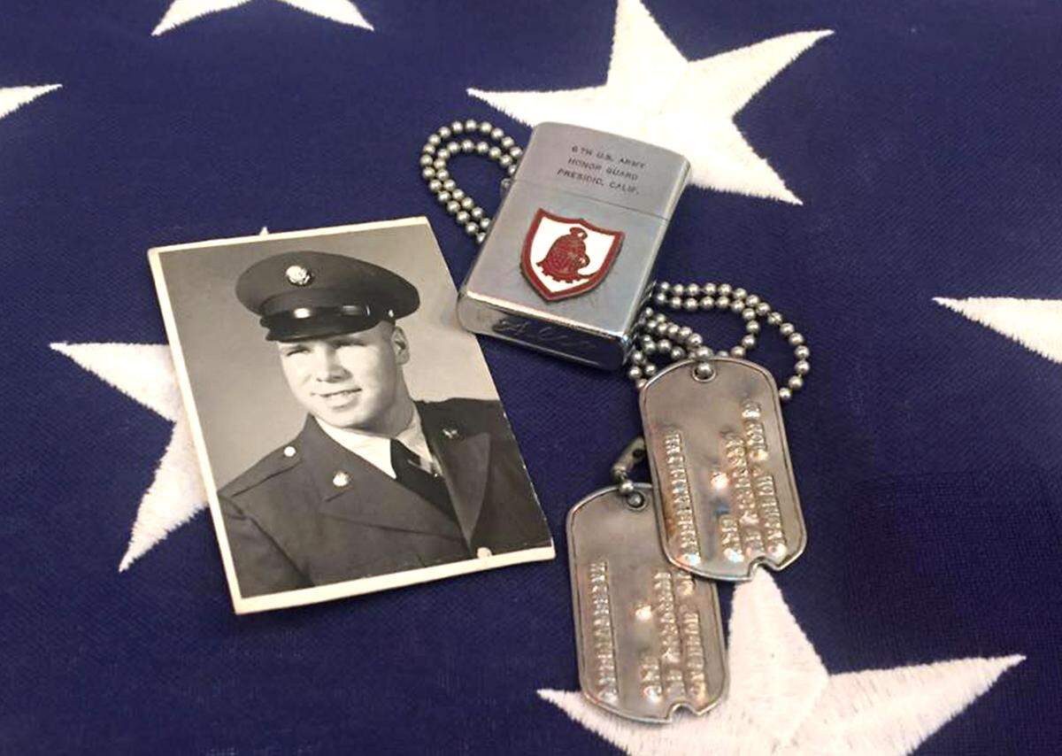 A portrait of Joe Jackson Sr. in uniform and his dog tags rest on top of an American flag. The Kennewick grandfather, who served two years in the Army, was given military honors at his graveside service after he died April 26 from complications of COVID-19.