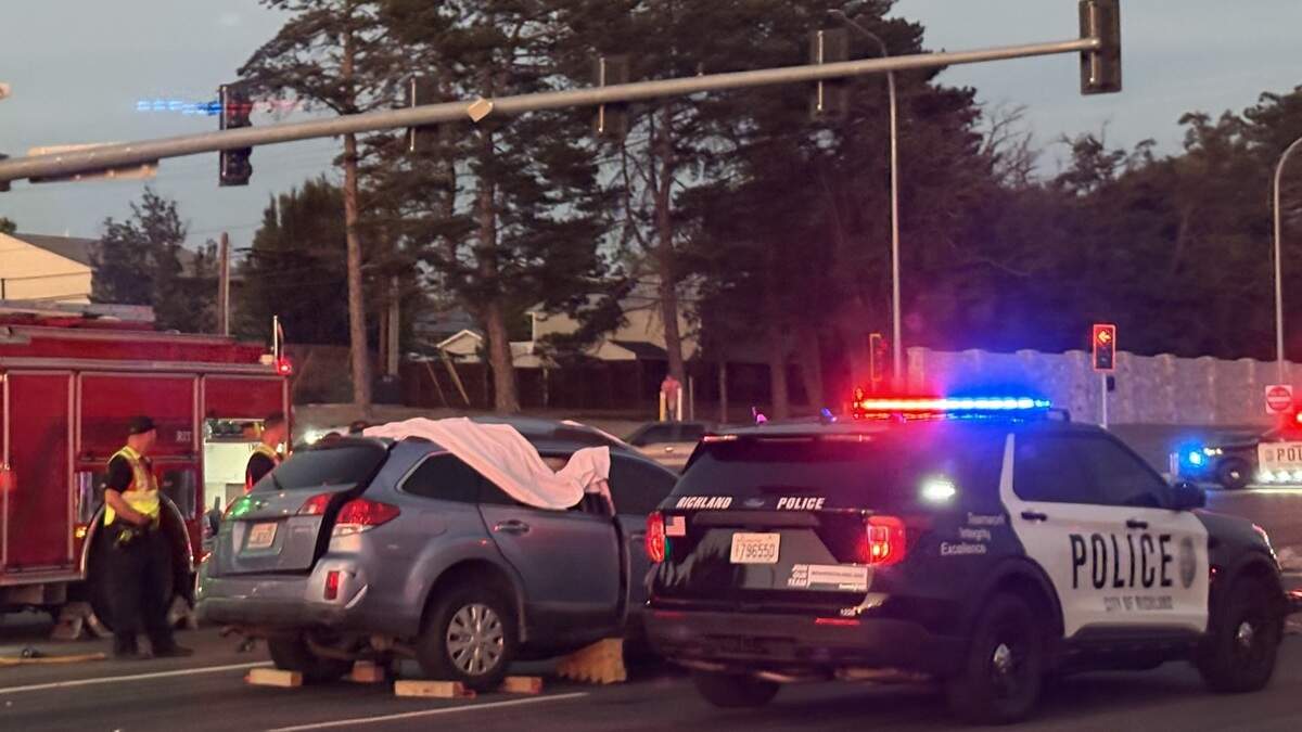 Richland police direct traffic around a fatal crash at Duportail Street and Highway 240 on Friday night.