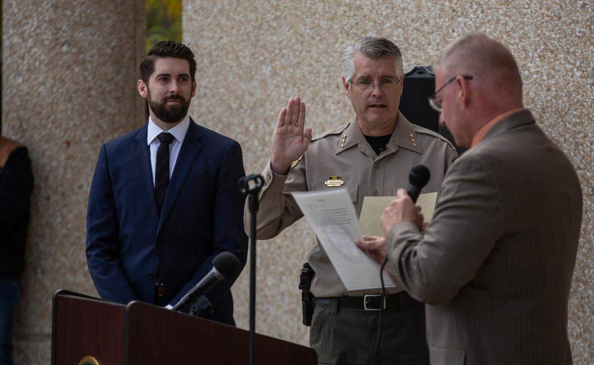 Tom Croskrey is sworn in as the new Benton County Sheriff by Benton County Commissioner Shon Small outside of the Justice Center in Kennewick on Oct. 4. 