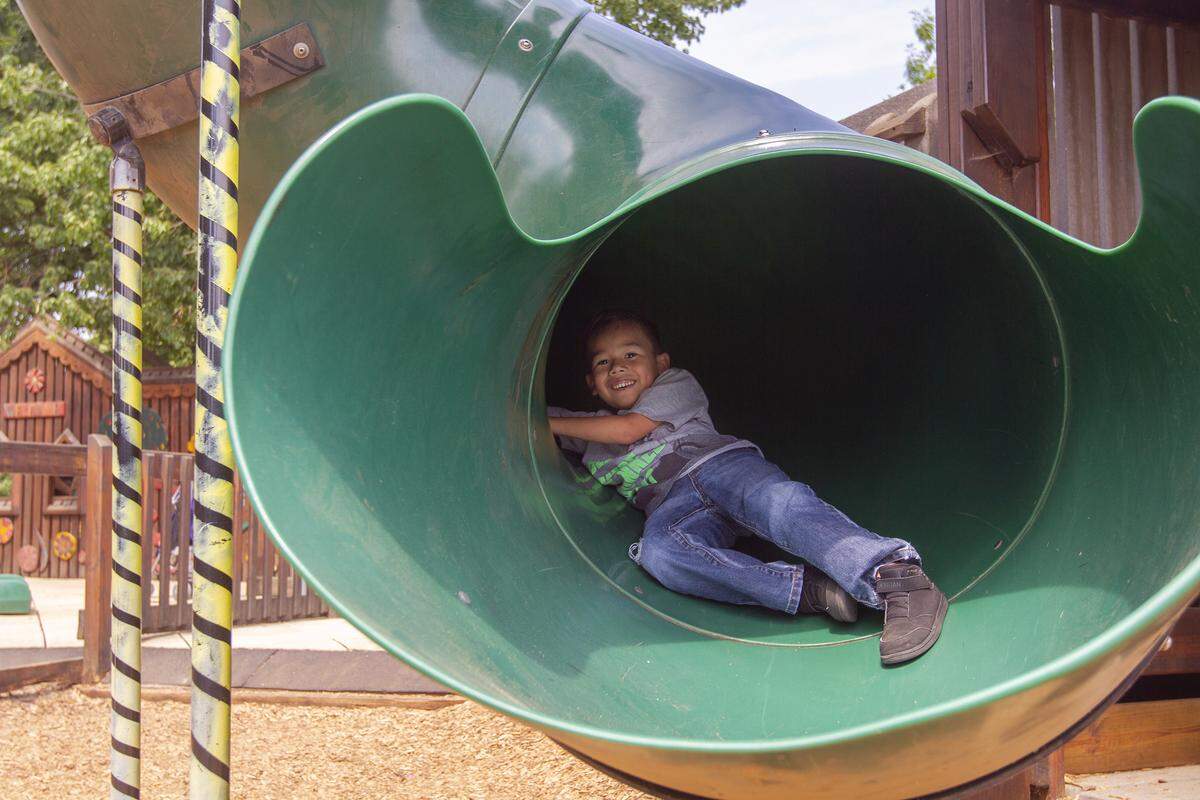 Yadam Alfaro, 5, rides down the slide at Playground Of Dreams at Columbia Park in Kennewick on Friday. Alfaro was accompanied by his mother Nereida Solorio of Eltopia.