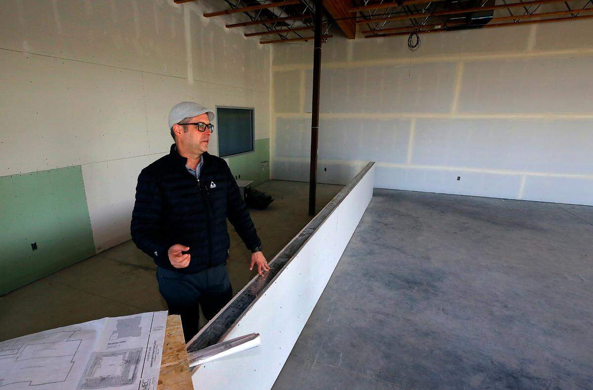 Jeffrey Ballard, restaurant operations manager, stands in the empty retail space in Pasco that will house the future Non-Fiction sandwich shop.