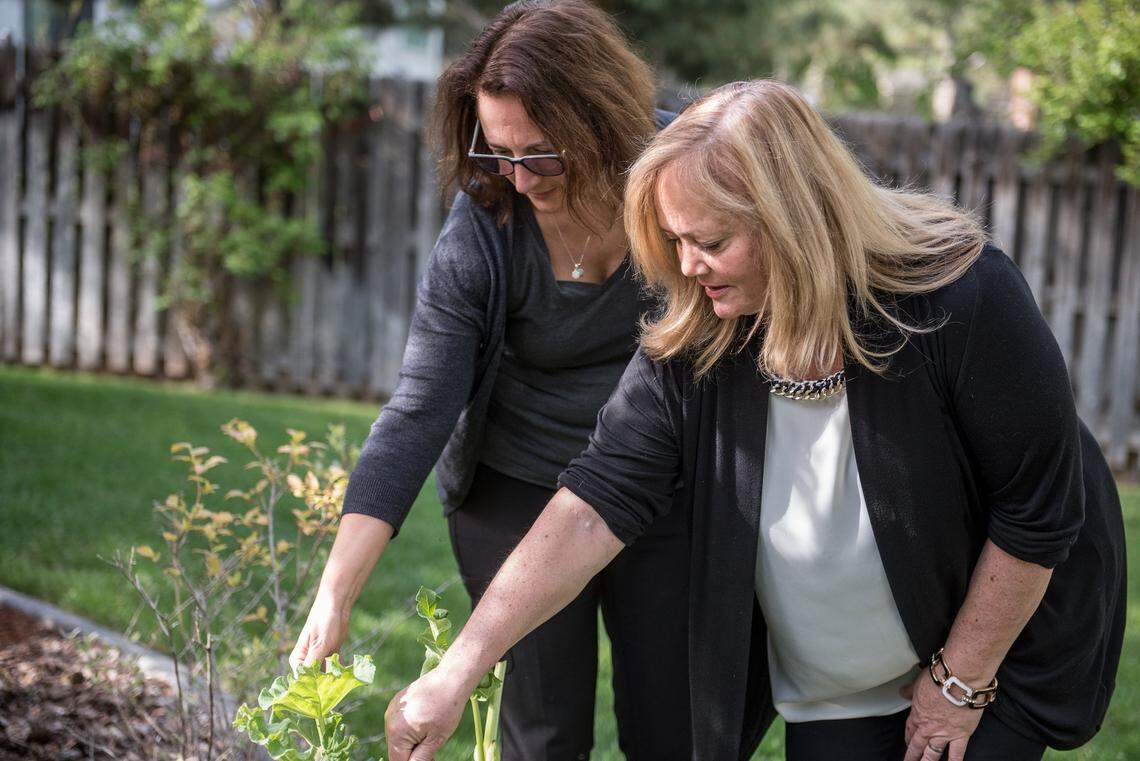 Dawn Johnson, left, shows Mary Frances Lembo around the garden of her Richland home in this 2017 photo.