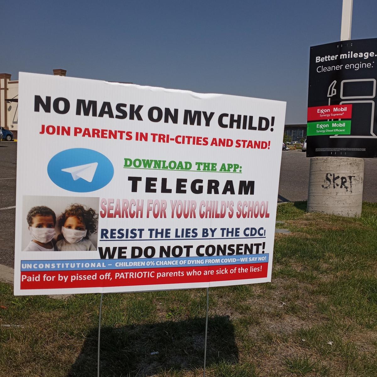 Signs around the Tri-Cities are encouraging parents and kids to resist the mask mandate in schools.