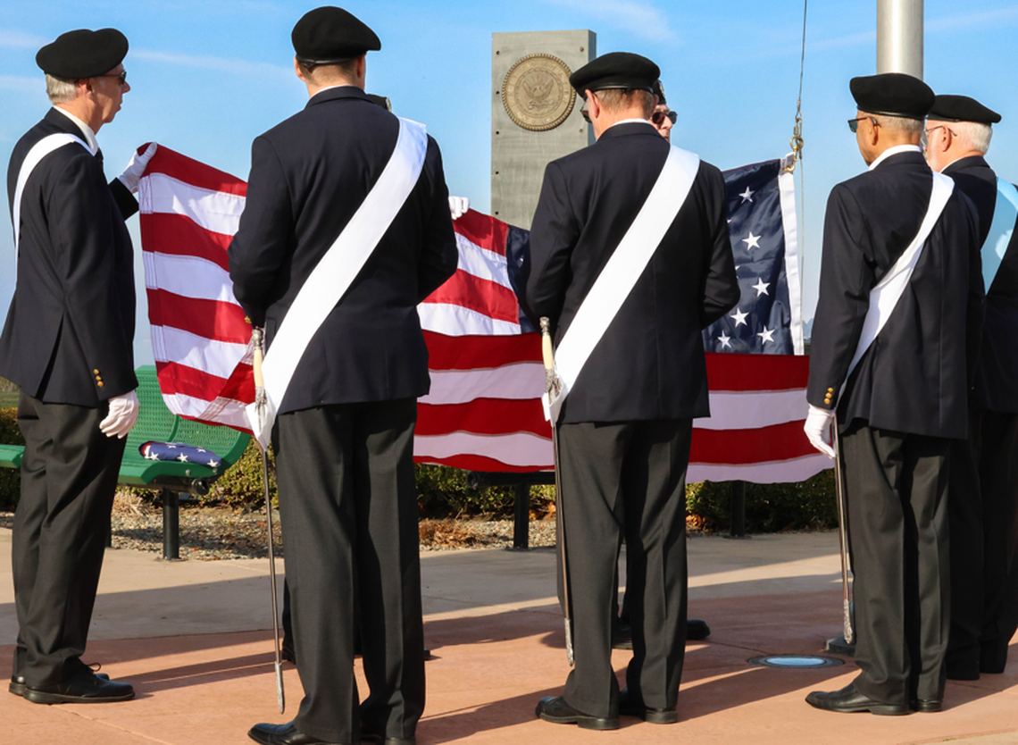 Members of the Knights of Columbus Honor Guard raise the flag during the Veterans Day ceremony in Kennewick.
