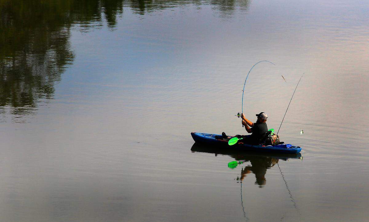 A kayak angler fishes near the causeway to Bateman Island at the Yakima and Columbia rivers in Richland.