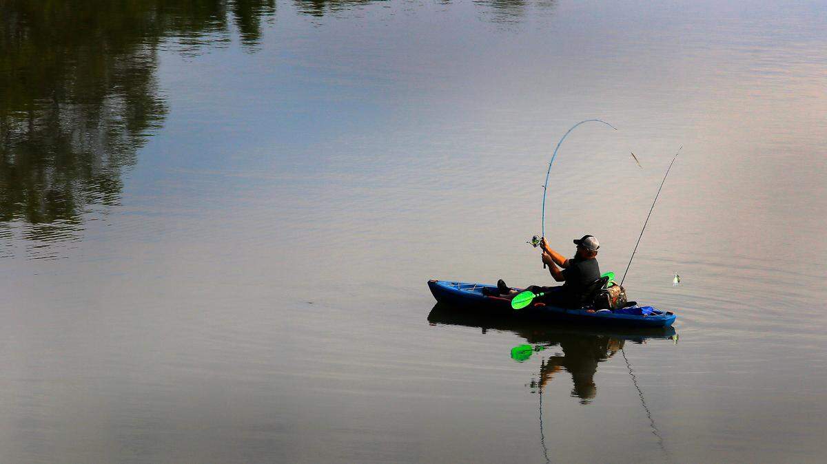 A kayak angler fishes near the causeway to Bateman Island off the Columbia River recently in Richland.