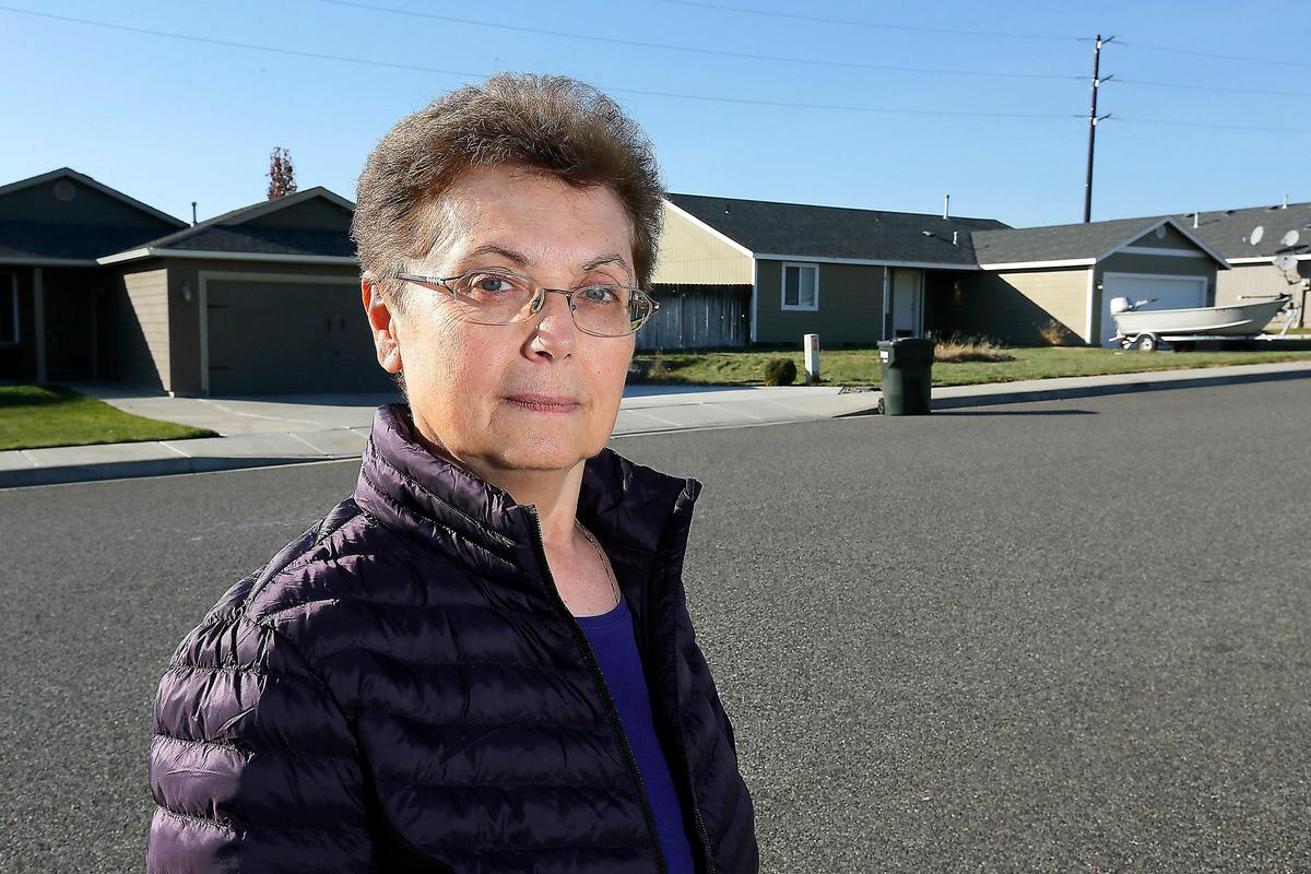 Vera Nenadic stands on John Deere Lane near where she and her dog were recently attacked by a pair of large dogs running loose in the west Pasco neighborhood. Watch a video at: tricityherald.com/video