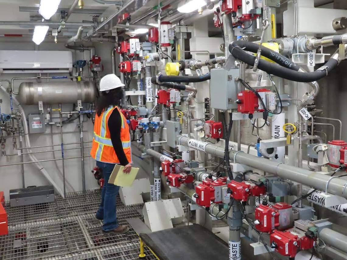 An employee of the Washington state Department of Ecology, a Hanford site regulator, takes a close-up look inside the Tank-Side Cesium Removal System’s process enclosure in September 2021.