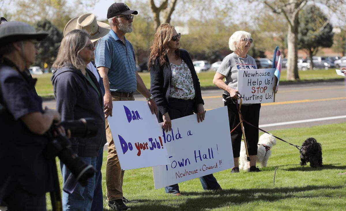About 75 to 100 gather outside the Richland office of Rep. Dan Newhouse during Wednesday’s rally organized by Indivisible Tri-Cities.