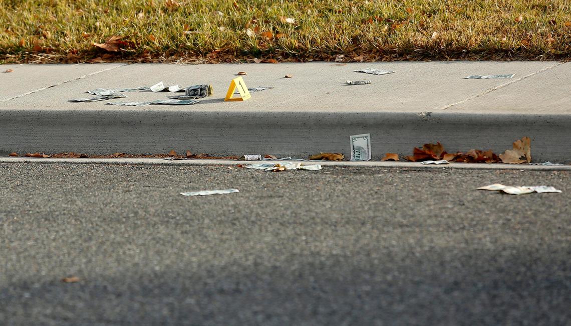 Money is scattered on the sidewalk and in the gutter of 1200 block of Winslow Avenue at the scene of a fight and shooting that sent two men to the hospital, one with several bullet wounds. Watch a video at: tricityherald.com/video.