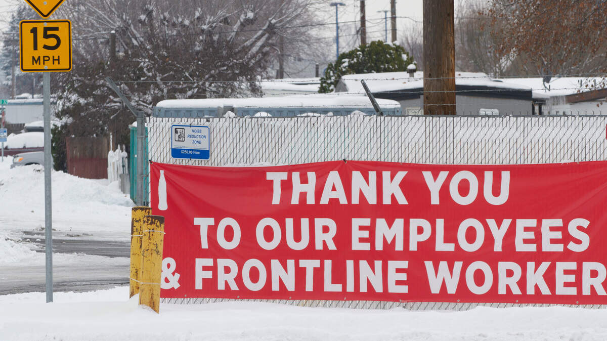A sign hanging outside of the Coca-Cola Bottling of the Tri-Cities in Pasco thanks employees and frontline workers for their contributions during the ongoing coronavirus pandemic.