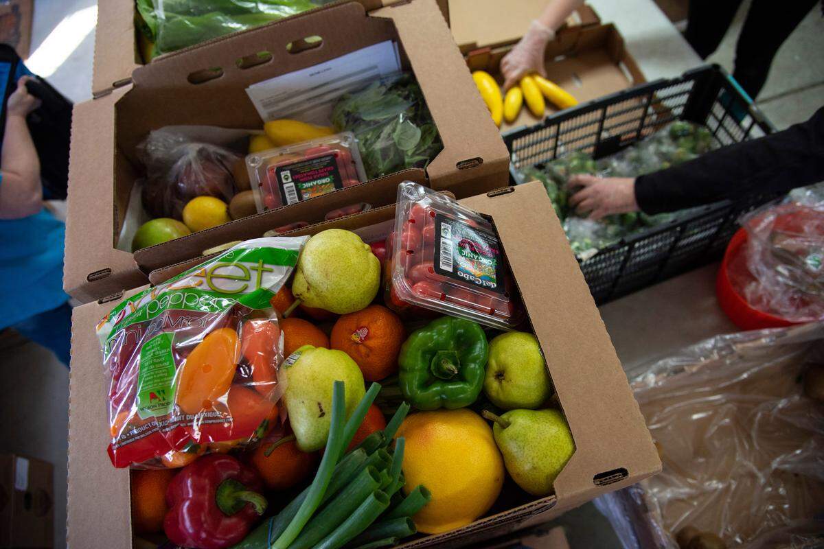Fresh produce is packed in to boxes at the Local Pumpkin warehouse in Pasco before deliveries. Local Pumpkin has seen a spike in demand for their produce boxes since the start of the coronavirus outbreak.