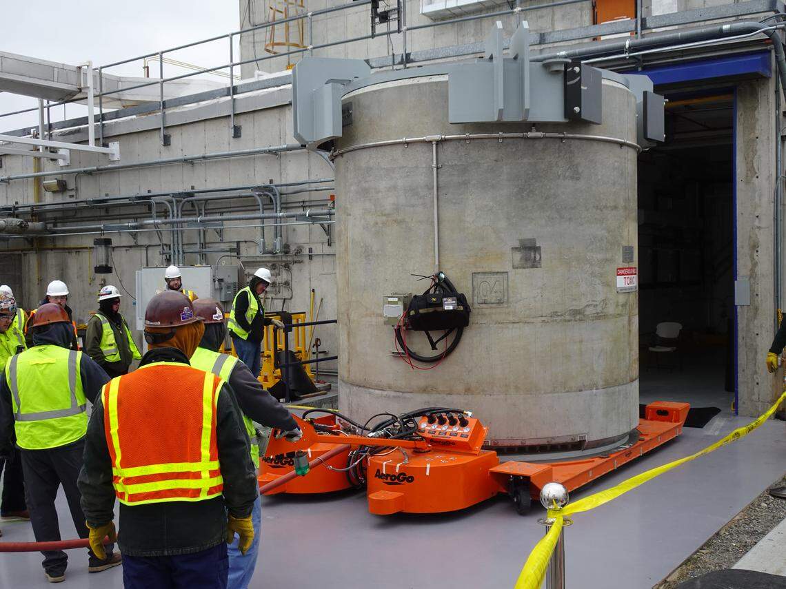 Workers pull the first concrete cask filled with cesium capsules out of the Waste Encapsulation and Storage Facility at the Hanford nuclear site in Eastern Washington.