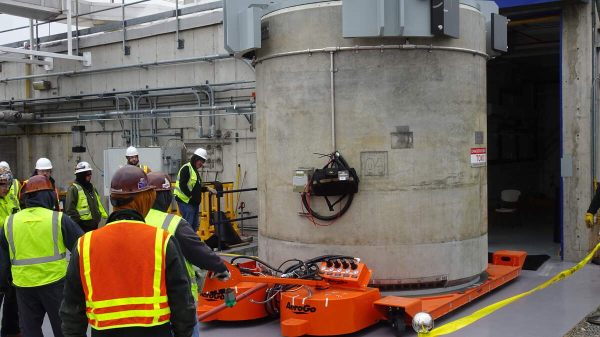 Workers pull the first concrete cask filled with cesium capsules out of the Waste Encapsulation and Storage Facility at the Hanford nuclear site in Eastern Washington.