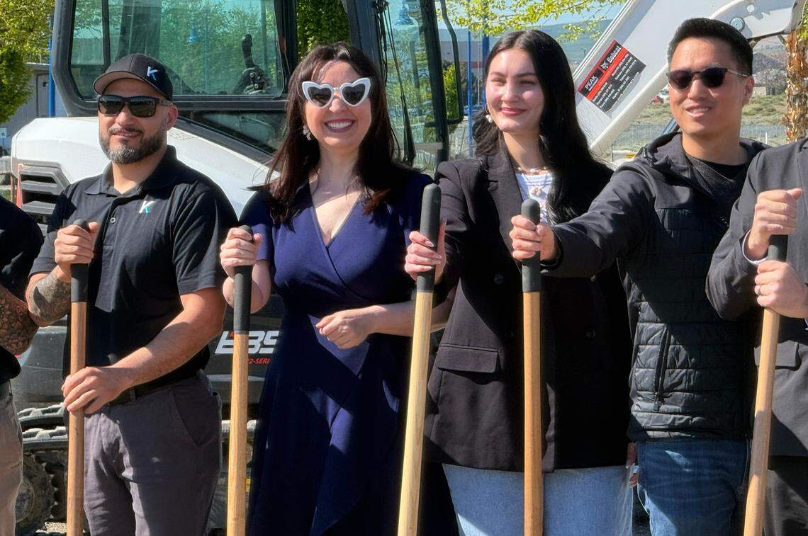 Amber Keller, white glasses, and her niece, Maddy, take part in the groundbreaking ceremony.