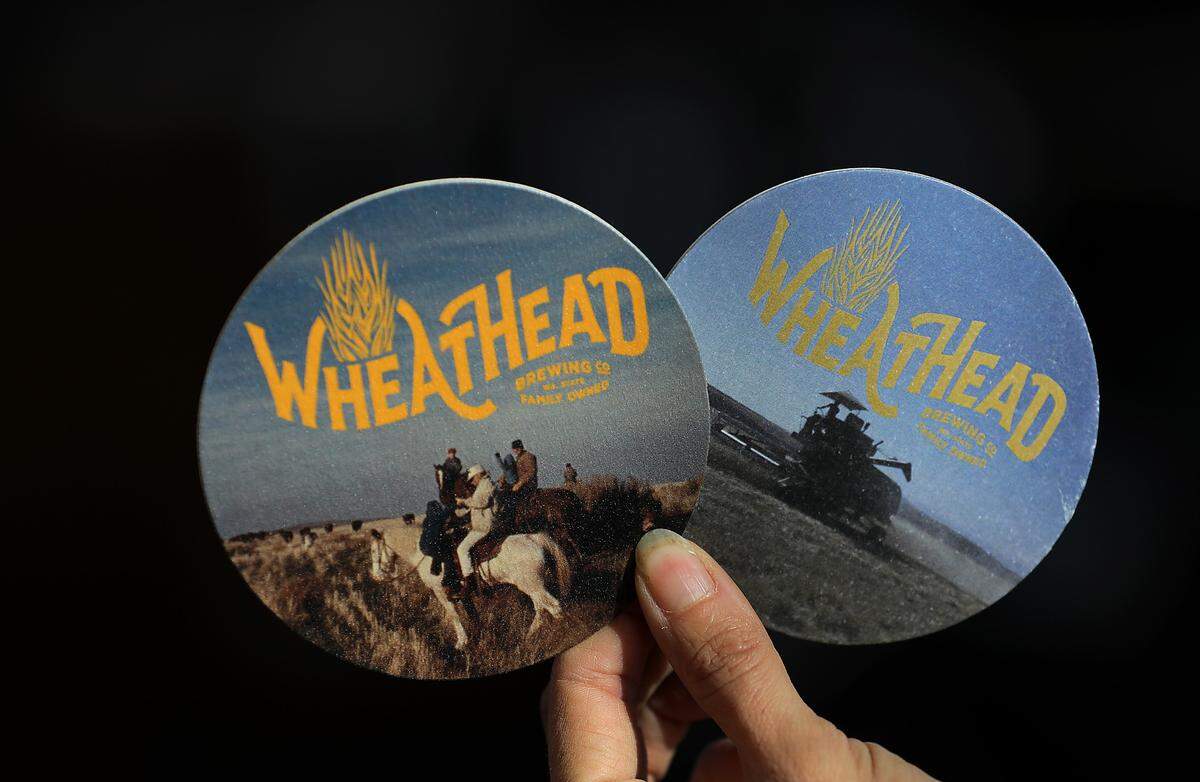 Phillips and Miller used old family photos from early farm life for the coasters they will use in their new Wheat Head Brewery.