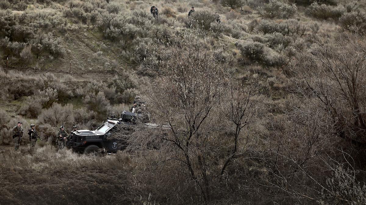 Man accused of murdering his brother-in-law is dead after standoff in Kennewick ravine