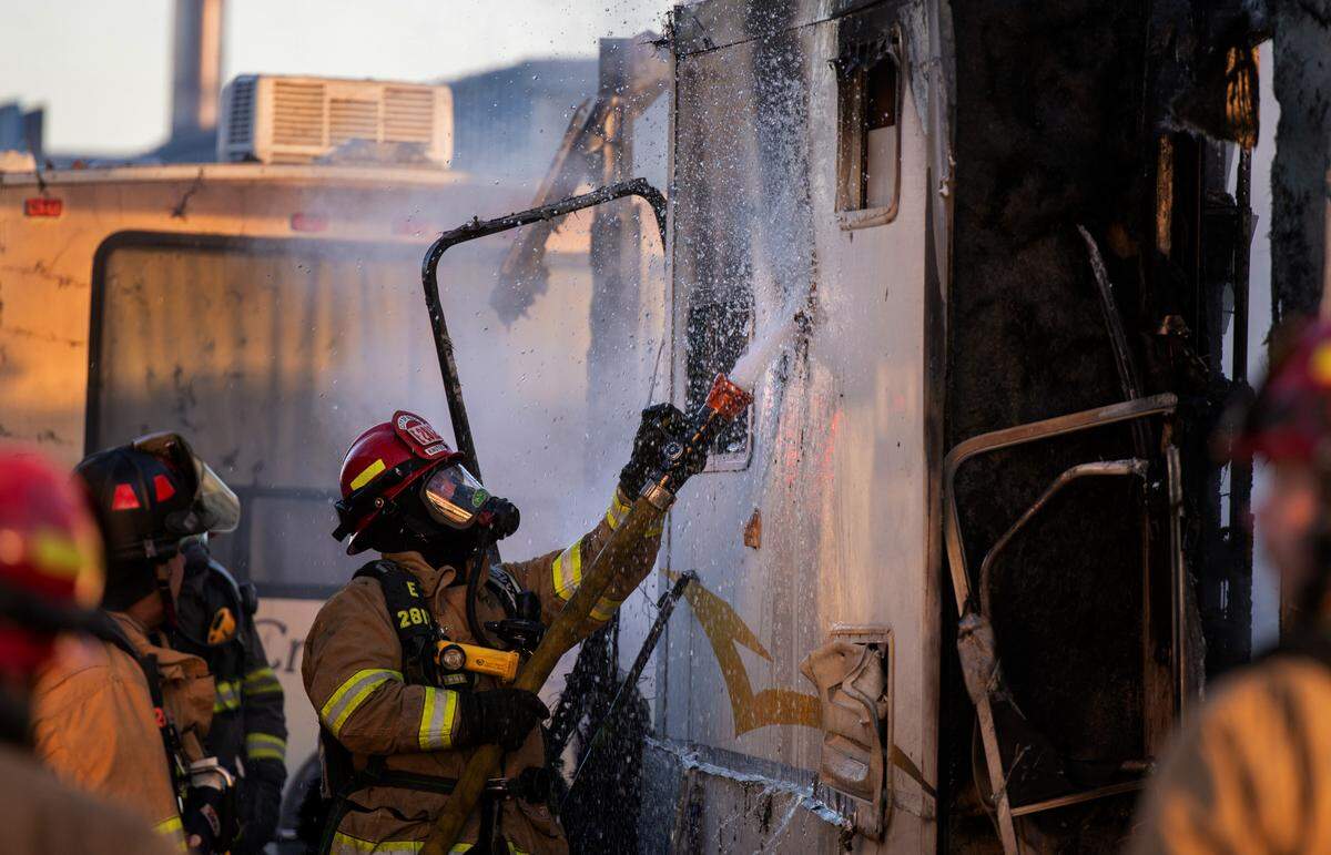 Firefighters work outside a heavily damaged trailer Thursday in the Green Tree RV Park and Mini Storage at 2103 N. 5th Ave. in Pasco. Fire officials say two adults and a child have been displaced because of the blaze that appears to have started in the living area of the trailer.&nbsp;No one was injured but a family cat died, according to Ben Shearer with the Pasco Fire Department.&nbsp;The Red Cross was called to assist the family.&nbsp;The trailer is considered a total loss.